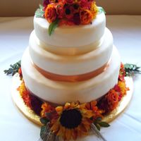 Harvest Flower Theme Fondant and silk flower-covered, fall-color themed wedding cake