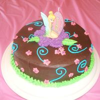 Tinkerbell Chocolate Chocolate cake with chocolate chips and chocolate buttercream icing. Tinkerbell is a candle and other decorations are buttercream. Inspired...