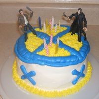 Wolverine & Sabertooth Strawberry cake w/ Buttercream icing. Birthday boy asked for Wolverine and Sabertooth toys on top. The X is the X-men symbol.