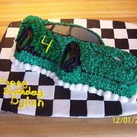 100_2361S.jpg Wilton Lightning McQueen cake done as a NASCAR racing car with fondant checkerboard squares
