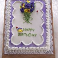 Pansies And Violets Birthday cake for group birthday. Buttercream with royal icing flowers,
