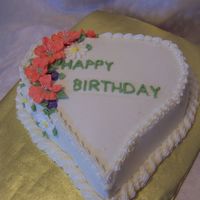 Heart-Shaped Birthday Cake Royal icing petunias and buttercream icing.