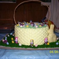 Easter Basket Cake Two Layer 10"x3" Round Cake with basketweave. The green grass is coconut. The handle I made out of gift bags. I just took them...