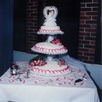 My Very First Wedding Cake This was my first wedding cake I have ever done. I did it for my big brother. It has fresh pink roses and corneli lace. Not bad for my...