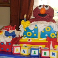 Elmo Present Cake Soooo soooo upset when my icing on elmo's body just kept getting darker. Actually cried