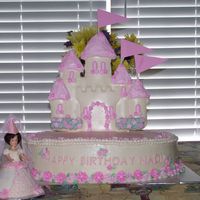 Princess Nadia's Castle Two layer oval chocolate cake with white chocolate pudding filling and buttercream frosting. Castle is made of white chocolate and...