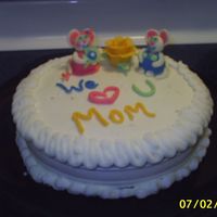 Mice For Mom White cake with chocolate whipped pudding filling and buttercream icing. The mice, flower, and writing is made from white chocolate candy...