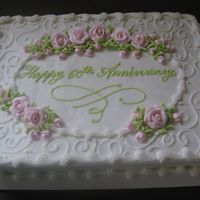 Anniversary This is an 11x15 sheet cake with pink royal icing roses. The rest is buttercream with a little glitter sprinkled on top!