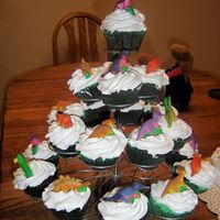 Dinosaur Cupcakes Edible dinosaurs on top of a marshmallow frosting.