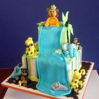 Jungle Animal Theme Baby Shower Vanilla Cake with Butter cream with fondant accents. Everything is edible. Cake was designed to match the napkins.