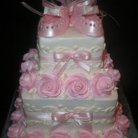 Laces_Pics_023.jpg Layers of white with straberry mousse and chocolate with caramel mousse. Iced in bc with bc roses snd scroll work. and baby shoes are made...