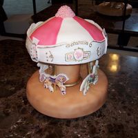 Carousel With Horses And Unicorns This is a 2 tier unicorn and horse carousel cake. Everything is edible. The horses/unicorns are printed on edible paper, the pillar is made...