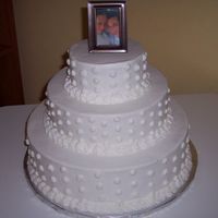3 Tier Swiss Dots Wedding Cake This was my first wedding cake. It is a white cake with rasberry filling and vanilla buttercream decorated with swiss dots.