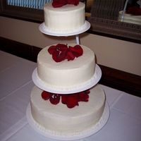 Basic Wedding Cake This is a basic buttercream wedding cake with flower petals on top. Simple but elegant.