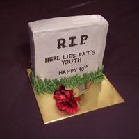 Headstone Cake This is an over the hill cake shaped like a headstone. The cake has internal dowels to add support so it can be "tall and thin"....