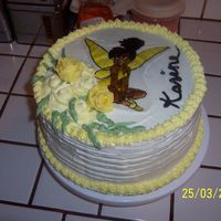 100_2988.jpg This cake was done for my daughters 25th birthday. All icing is butter rum. The cake was carrot cake. Tinkerbell, was drawn on rice paper...