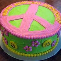 Peace, Love, & Tie Dye Vanilla and Strawberry tie dye cake decorated with buttercream