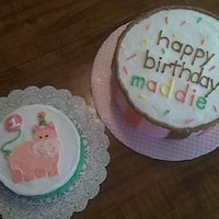 Baby Zoo First Birthday Vanilla Cake with triple berry filling, buttercream icing. Smash cake has hippo from the themed plates.