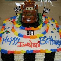Cars Tow-Mater Birthday Cake Chochlate Cake with traditional buttercream icing made with heavy cream. All decorating done with buttercream icing. Wilton Star Sprinkles...