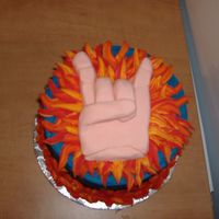 The Fist Of Rock My husband dared me to do a cake that was a fist of rock, a la Duff Goldman. He didn't think I would really do it!The fist is MMF, the...