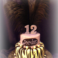 Jordan's Zebra/feather Cake This is my daughter's 12th birthday cake. The bottom zebra tier is a 9" lemon and the top tier is a 6" chocolate. Both have...