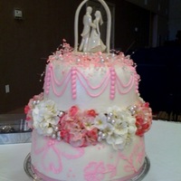 Pink Bliss Bottom layer is a 10 inch with buttercream covered in MMF with free hand brush embroidery. Top layer is 8 inch, buttercream covered in MMF...