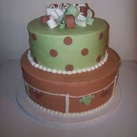 Neutral Clothesline Cake Top tier is white cake with Raspberry filling, bottom tier is a mexican chocolate cake with cinnamon mouse filling.All covered in...
