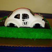 Herbie I made this for my 4year olds birthday. The bottom is a 9x13 pan. The car is the wilton car pan rounded with bcream icing and covered in...