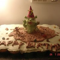 Baby Shrek Cupcake Cake Cupcake cake with baby shrek made from mini bear pan. covered in whipped icing and edible rocks