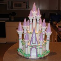 Daughter's First Birthday Cake my first castle cake. I thought it went pretty good. filled and iced in buttercream, the flowers are fondant.