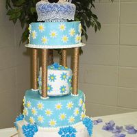 Blue Western Wedding Butter Creme with Royal BlueBells and Fondant Dasies, the Pillars are wrapped in a gold "rope" My first custom cake topper