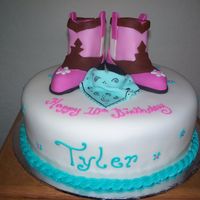 Cowgirl Boots 10in round covered in fondant. Boots are sculpted yellow cake covered in fondant.Scarf is 50/50 fondnat & gumpaste