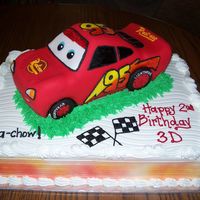 3D's Cake First time at sculpting. I used a toy car as a guide. Bottom cake is marbe filled with strawberries. Iced with extra special buttercream.