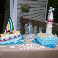 Baby_Shower.jpg Baby Shower Nautical Cake. Sail boat covered in fondant. Square cake covered in butter cream. Light house made out of pastillage. Details...