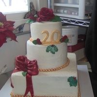 Linda And Dewey- 2Oth deepred life-size roses , gold pearls, large red bow, done with disco dust from Sunflower /all over cream cheese butter cream covered...