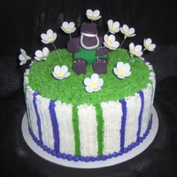 Barney In The Flowers fondant figure and gum paste fantasy flowers on buttercream icing