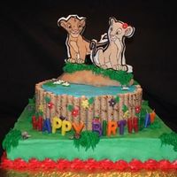 Lion King Cake iced in buttercream with fondant flowers.