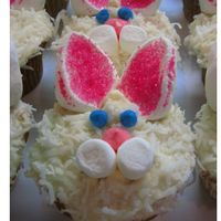 Bunny Cupcakes :) Vanilla cupcakes with french buttercream frosting, topped with coconut. Marshmellos cut in half for ears, sprinkled with pink sprinkes....