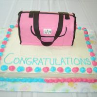 Diaper Bag Cake This is a WASC cake with a replica of a Dooney & Bourke diaper bag on top. Diaper bag is covered with fondant.