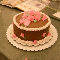 Course 1 Graduation Cake This was my final cake in Course 1. I tried the chocolate BC just for fun. My icing was a bit too stiff, so my roses and bow look kind of...