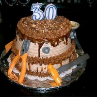 30Th Birthday Tool Cake I made this for my husband's birthday. It's a Snickers cake, and my first attempt at a stacked cake. The tools are plastic toys....