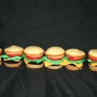 Hamburger Cupcakes My attempt. I used fondant for all the "works" on the burger. Ad the bun and meat are cake. For the meat I just made a square...