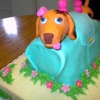 Dog In A Purse This cake was a joint effort with two other co-workers to make a retirement cake for co-workers. The dog was a Weiner dog modeled after the...