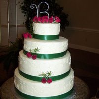 Kristen's Wedding Cake butter cake with whipped milk chocolate ganache. 14", 12", 10" and 6" layers. satin ribbon and fresh roses.