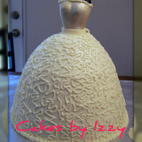 Allie's Engagement wilton doll pan. used a doll pick for the form. ripped off her head and arms (LOL!) and covered it with black fondant. top of dress is...