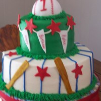 At The Old Ballgame made for a 1 year old with coordinating smash cake. baseball is RKT covered in fondant, cake is butter with buttercream and fondant accents...