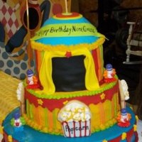 1288975280.jpg white cake, chocolate cake and funfetti cake. buttercream and fondant accents. had the most fun with this cake. popcorn boxes are sugar...
