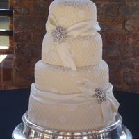 Grandma's Lace And Brooch This is a fondant covered cake with a buttercream lace and fondant applique design. The design was inspired by Grandma's favorite...