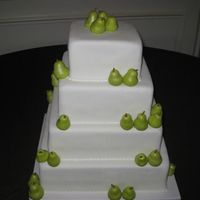 Pear Wedding 4 tier all cherry almond cake with marionberry filling covered in MMF. Pears were hand made with gumpaste and sprayed to add shimmer. This...