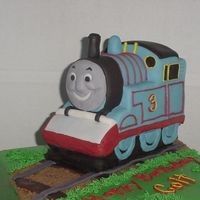 Thomas The Train Thomas is chocolate pound cake covered in fondant and the base cake is covered in BC.